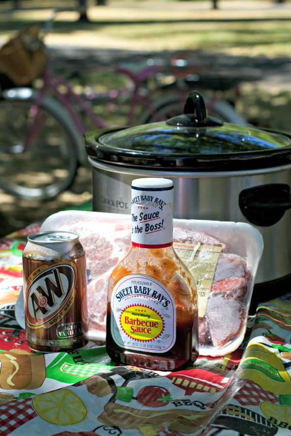 pork, root beer and barbecue sauce in front of slow cooker