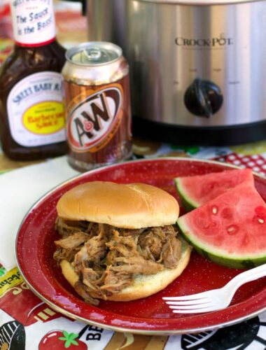 root beer pulled pork on bun with water melon on side