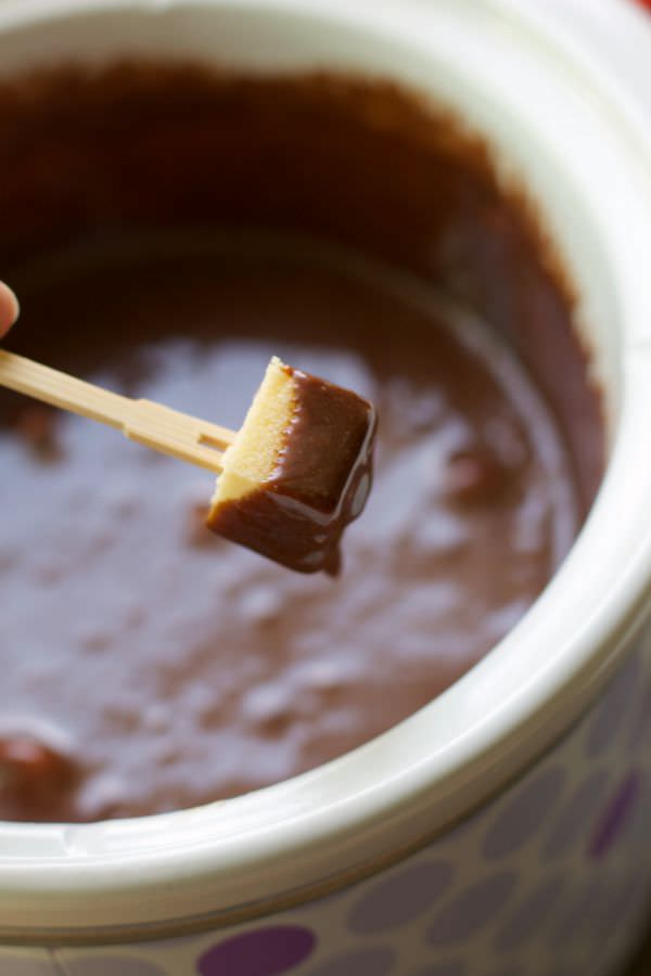 Pound cake dipping in slow cooker candy bar fondue