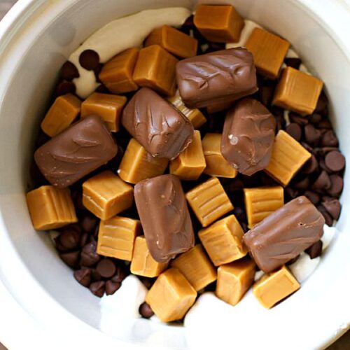 candy bars, caramel and marshmallow fluff in slow cooker