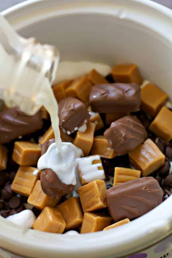 Cream pouring into candy bars in crockpot.