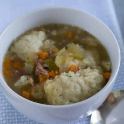 ham hocks and dumplings in white bowl