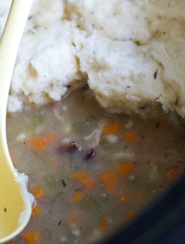 ham hock soup with dumplings on top in slow cooker