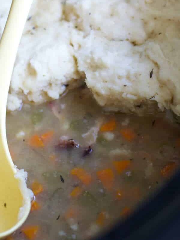 ham hock soup with dumplings on top in slow cooker
