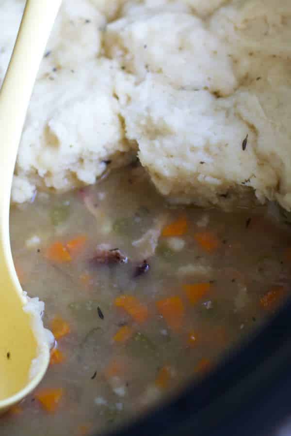 ham hock soup with dumplings on top in slow cooker