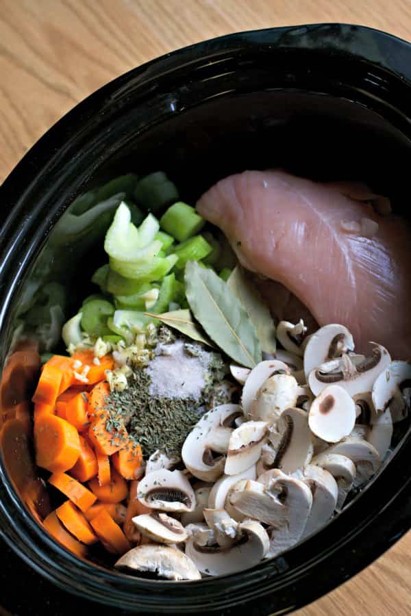 Ingredients for turkey soup: Turkey, celery, carrots, mushrooms, garlic, bay leaves, and seasonings.