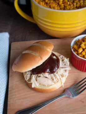 shredded chicken sandwich with barbecue sauce on top.
