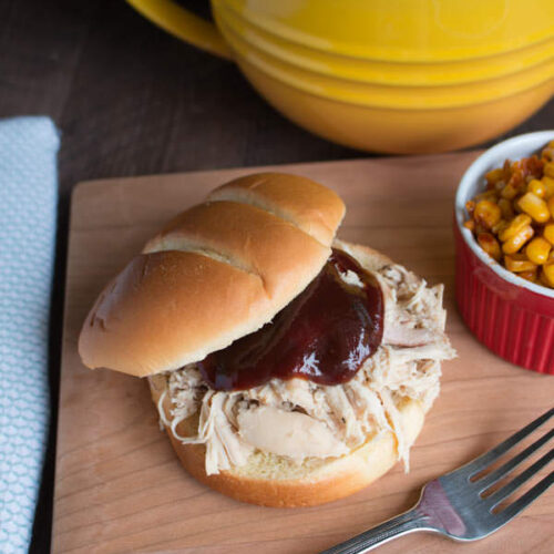 shredded chicken sandwich with barbecue sauce on top.