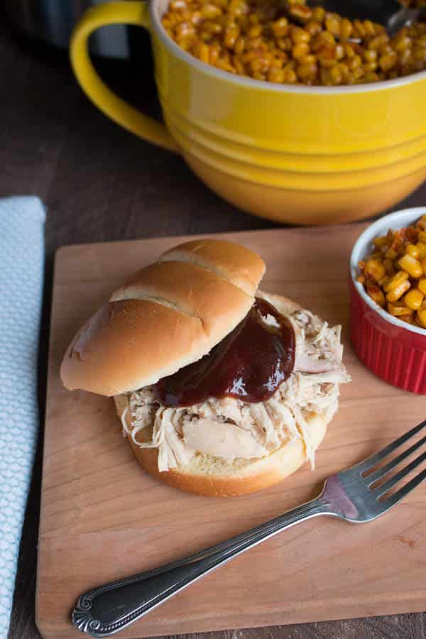 shredded chicken sandwich with barbecue sauce on top.