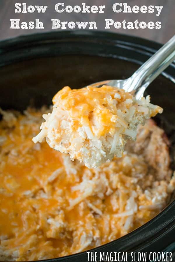 Cheesy hashbrowns in slow cooker, with metal spoon scooping out a scoop.