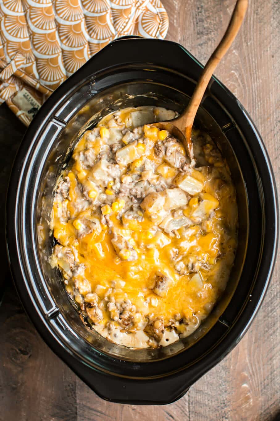 diced potatoes, corn and cream of mushroom soup cooked with cheese on top in slow cooker.