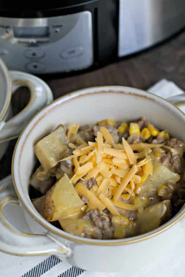 bowl of hamburger hash with cheddar cheese on top