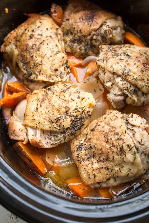 Chicken thighs on top of brothy sweet potatoes and onions.