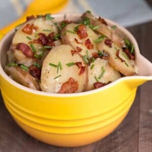 sliced hot potato salad in yellow bowl