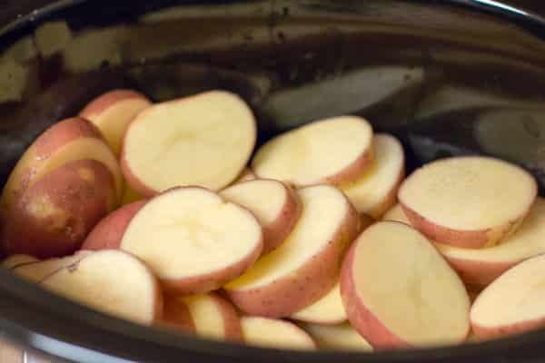 Sliced red potatoes in slow cooker