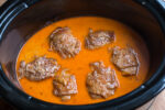 Six chicken thighs in paprika cream sauce in slow cooker