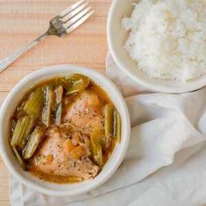bowl of pepper chicken with rice on side.