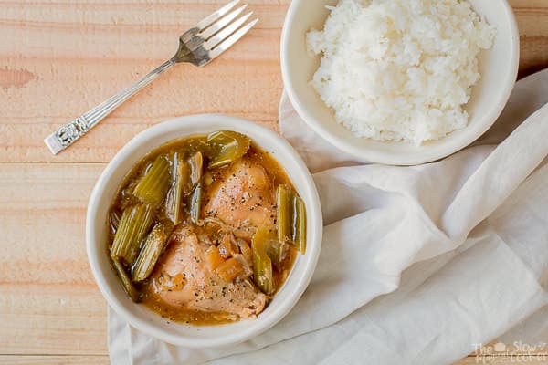 bowl of black pepper chicken with bowl of white rice with  fork on side.