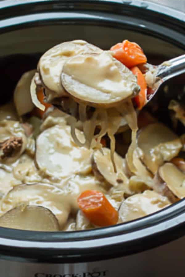 Scoop of potato, meat and vegetable casserole from slow cooker.