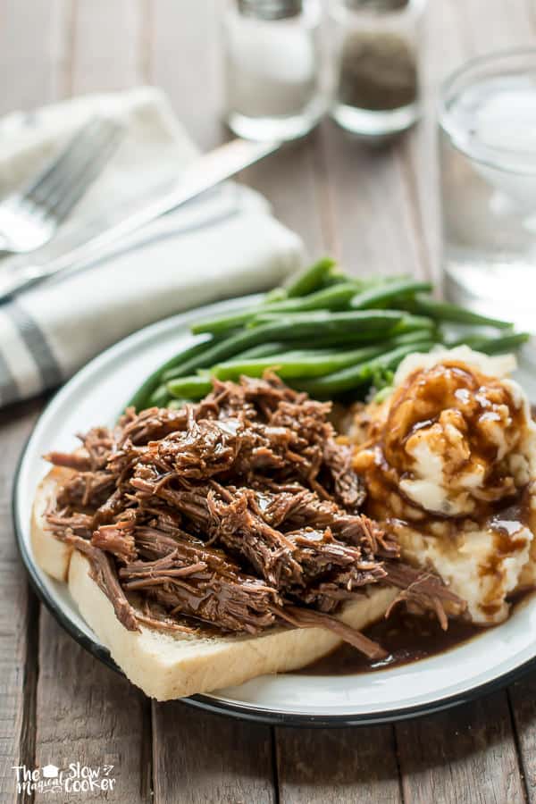 shredded beef on bread with mashed potatoes and green beans