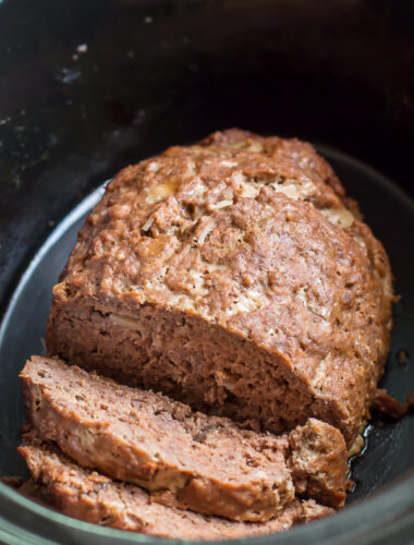 Onion meat loaf partly sliced in slow cooker