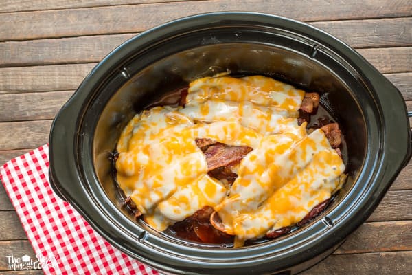 pork chops with cheese and bacon on top.