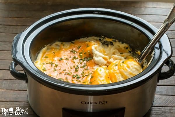 Slow cooker full of cheesy mashed potatoes.