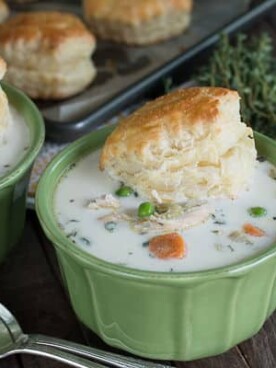 two bowls of chicken pot pie soup in green bowls