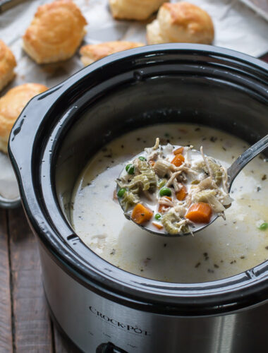 Ladle of chicken pot pie soup, scooping from crock pot.