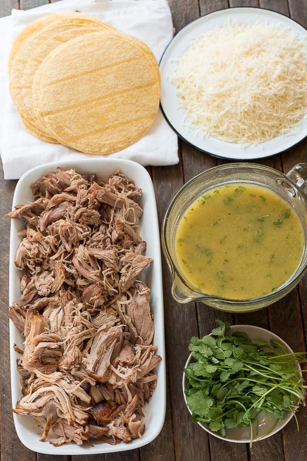 shredded pork, green enchilada sauce, cheese, corn tortillas and cilantro in dishes.