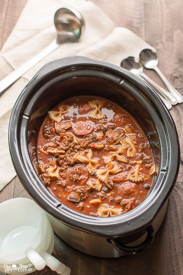 Pizza soup in slow cooker with bowtie pasta