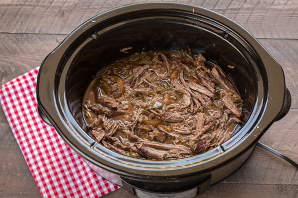 shredded beef in slow cooker in juices