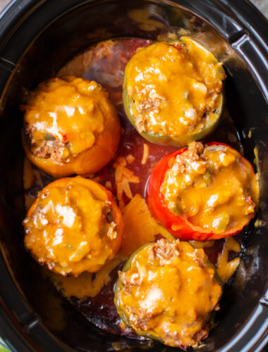 Cheesy taco meat loaf peppers in slow cooker sitting in salsa