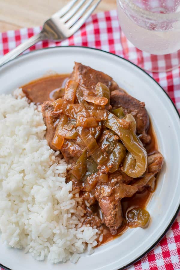 close up of barbecue country ribs on plate with white rice.