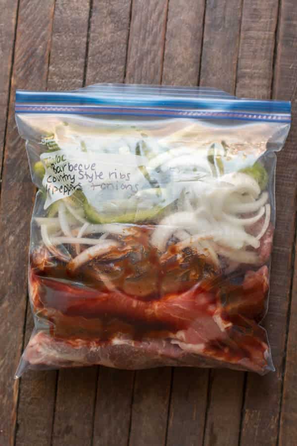 country style ribs, bell peppers, onions, and barbecue sauce in plastic freezer bag.
