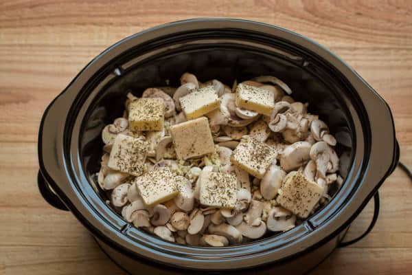 onion, mushrooms, seasonings and butter in the slow cooker, uncooked.