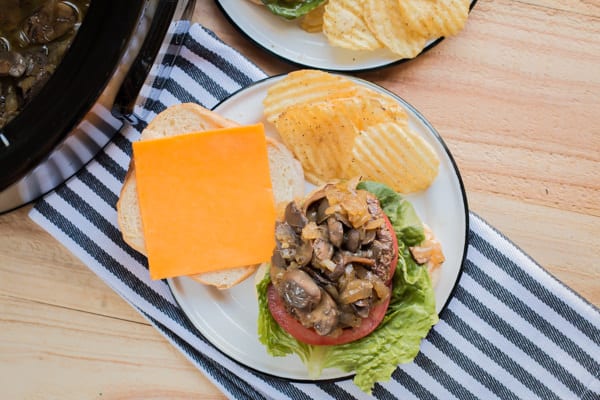 hamburger with mushrooms and onions on top.