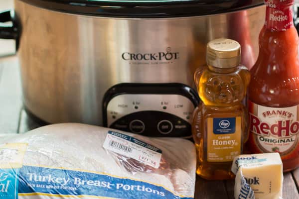 packaged turkey breast, honey, buffalo sauce and butter in front of slow cooker
