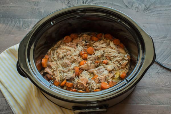 shredded chicken and carrots in a slow cooker