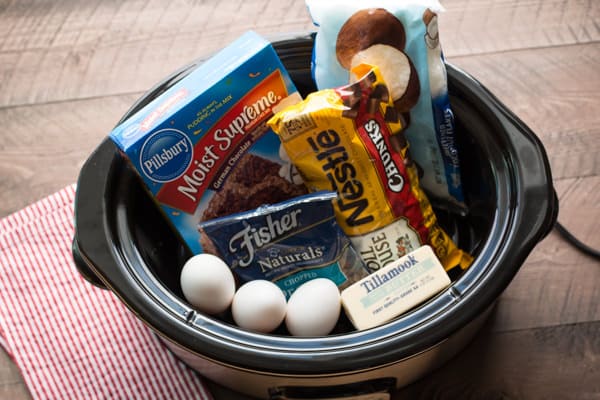 Cake mix, chocolate chips, pecans, coconut, eggs, and butter in a slow cooker.