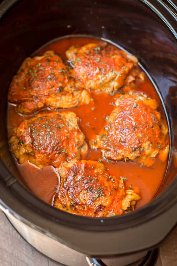 close up of hot chicken thighs in the slow cooker.