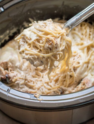 chicken tetrazzini on a ladle coming from a slow cooker.