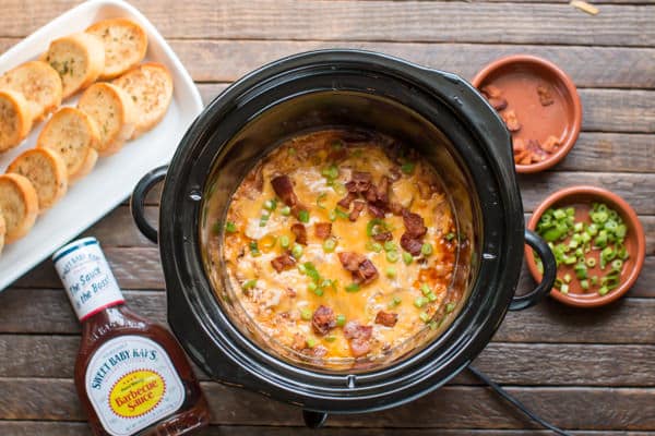 cooked barbecue chicken dip with bread slices on the side.