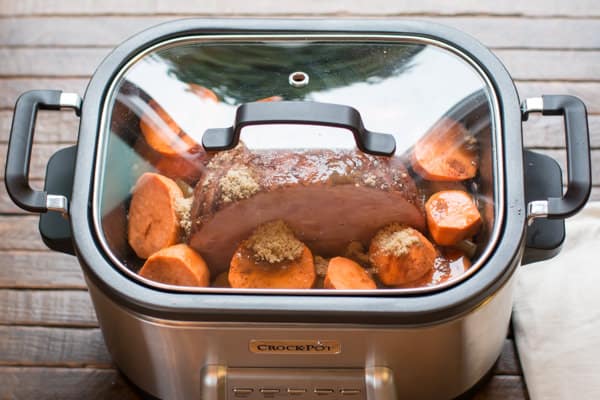 lid on slow cooker with ham and sweet potatoes in it.