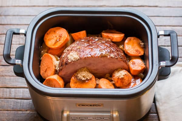 black forest ham and sweet potato slices in a slow cooker.