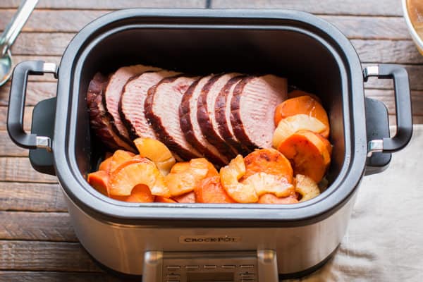 sliced ham, sweet potaotes and pineapple in a slow cooker.