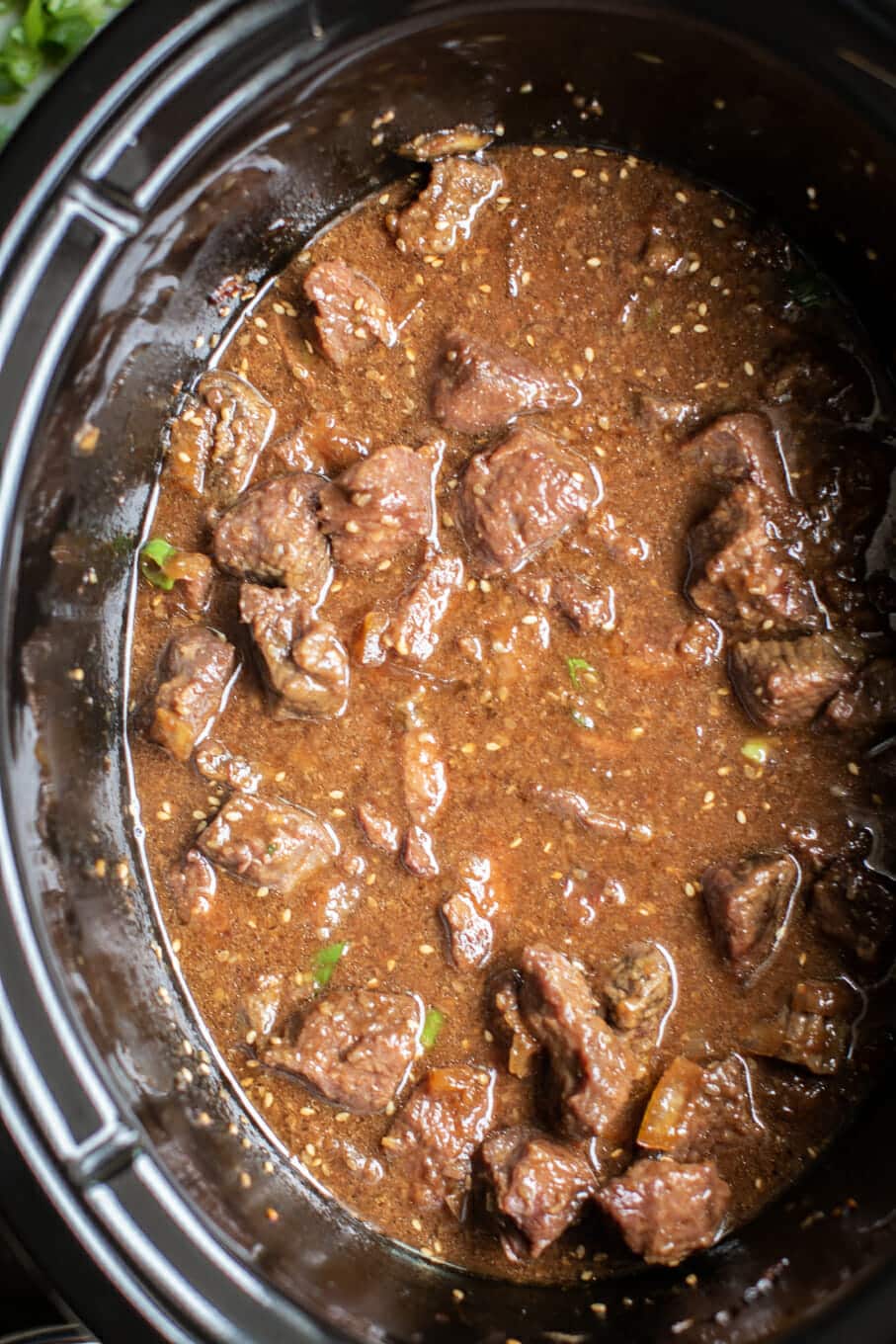 close up of beef in rich teriyaki sauce in the slow cooker.