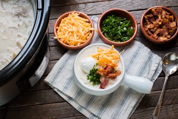 bowl of soup with topping in bowls on the side.