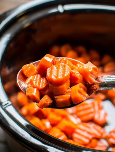 close up of spoon with candied carrots on it.