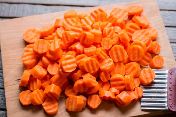rippled sliced carrots on a cutting board.